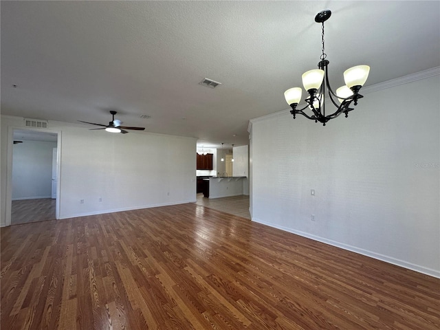 empty room featuring visible vents, baseboards, wood finished floors, and ceiling fan with notable chandelier