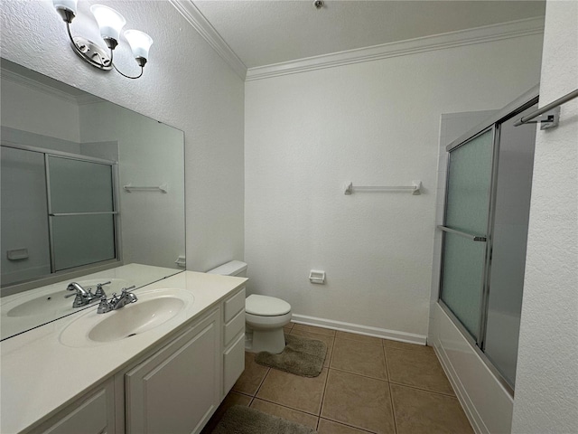 bathroom featuring tile patterned flooring, crown molding, baseboards, toilet, and vanity