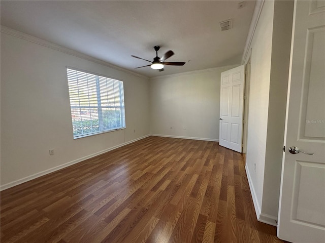 spare room with wood finished floors, baseboards, visible vents, ceiling fan, and ornamental molding