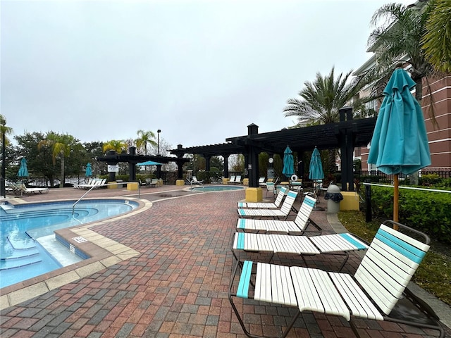 community pool with a patio area and a pergola