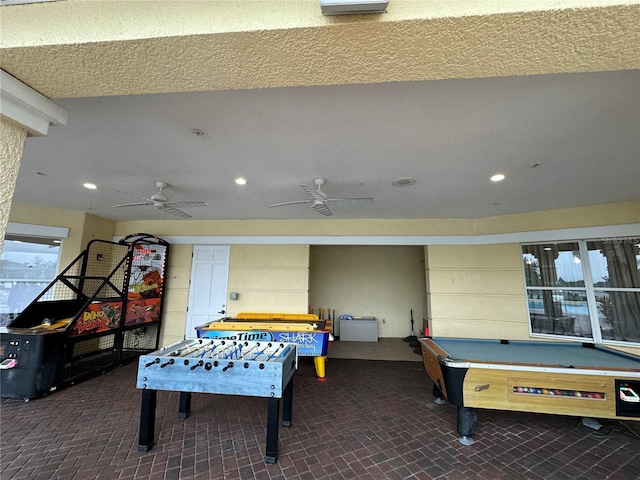 recreation room featuring recessed lighting, brick floor, and ceiling fan