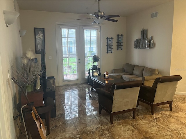 living room featuring ceiling fan and plenty of natural light