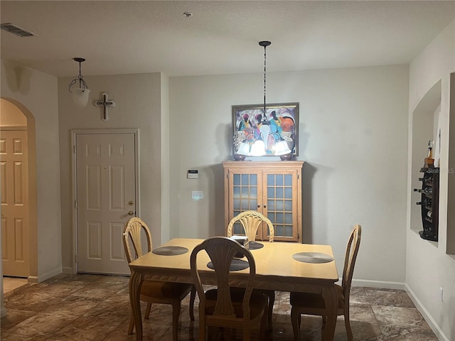 dining area featuring a notable chandelier