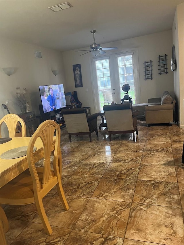 dining space featuring ceiling fan and french doors