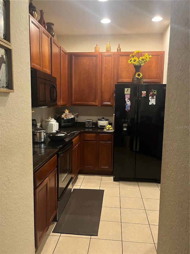 kitchen with light tile patterned floors and black appliances