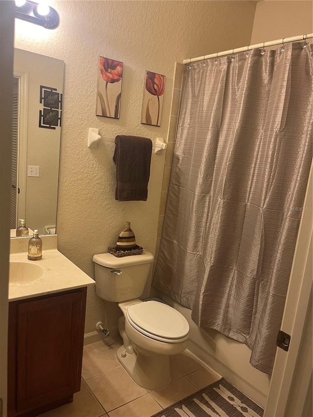 full bathroom featuring tile patterned flooring, vanity, toilet, and shower / bath combination with curtain