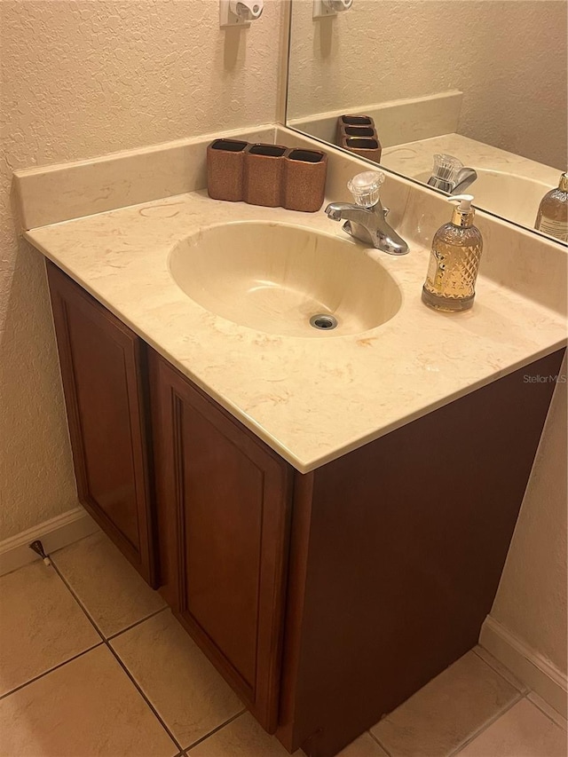 bathroom with tile patterned flooring and vanity