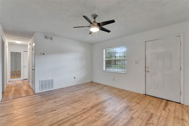 interior space featuring ceiling fan, a textured ceiling, and light hardwood / wood-style floors