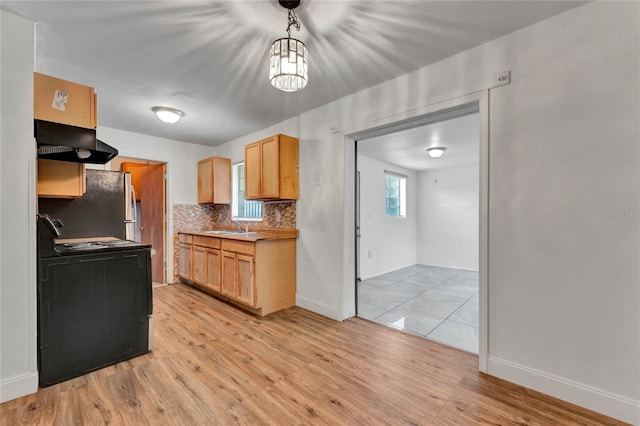 kitchen featuring light brown cabinets, black range with electric cooktop, and light hardwood / wood-style flooring