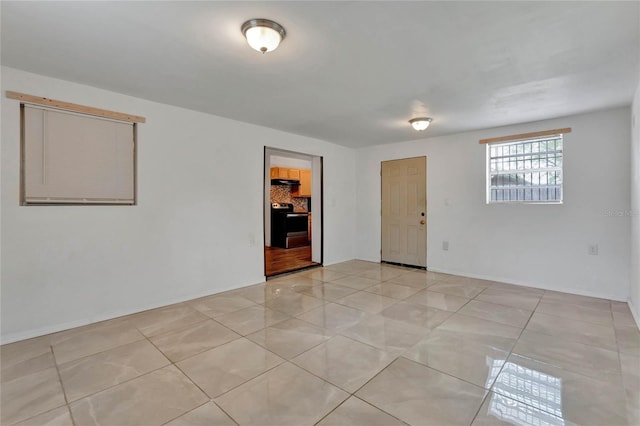 spare room featuring light tile patterned flooring