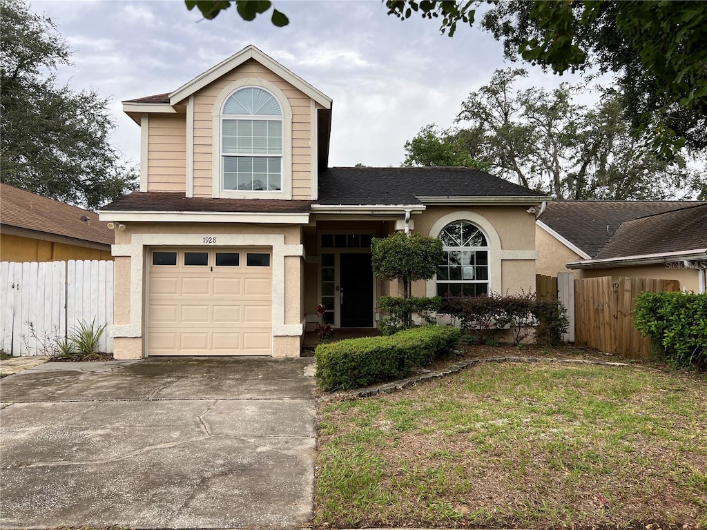 front facade with a garage and a front yard