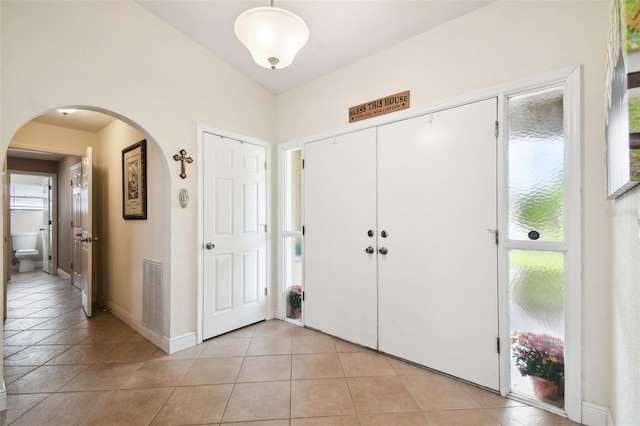 entryway with light tile patterned flooring