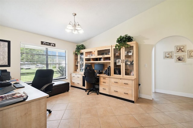 office featuring vaulted ceiling, light tile patterned floors, and a notable chandelier