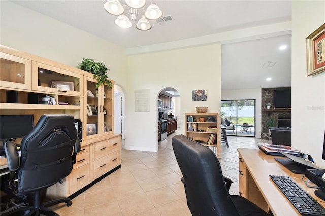 home office with an inviting chandelier and light tile patterned flooring