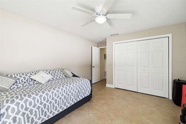 bedroom with a closet, ceiling fan, and light tile patterned floors