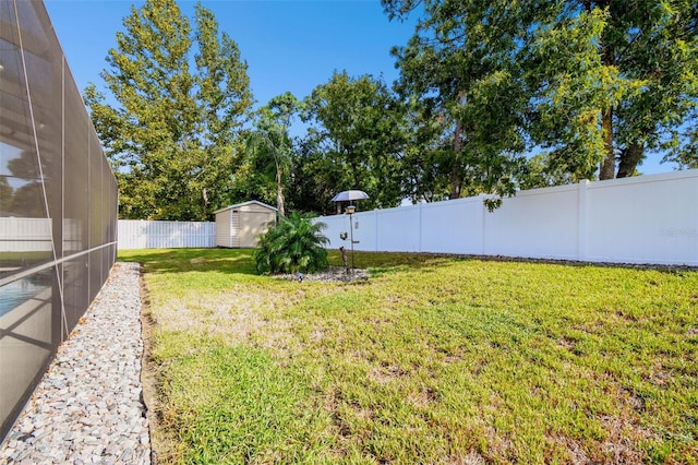 view of yard with a shed and a lanai