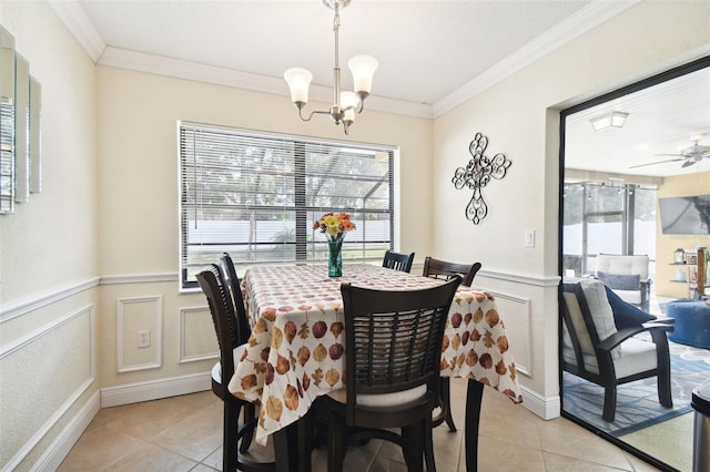 dining room featuring ceiling fan with notable chandelier, light tile patterned floors, and crown molding