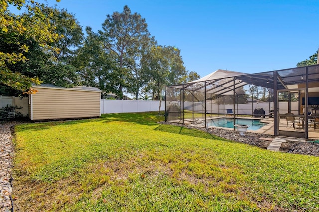 view of yard featuring a lanai, a patio, a storage shed, and a fenced in pool