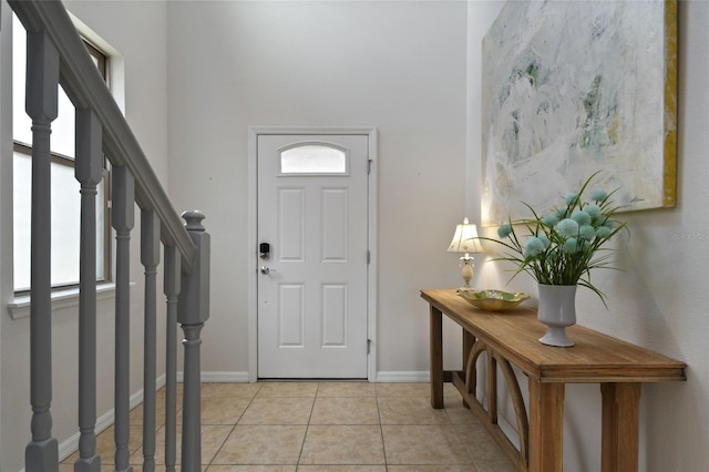 entrance foyer featuring light tile patterned floors and a healthy amount of sunlight