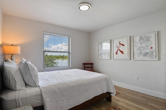 bedroom with hardwood / wood-style flooring