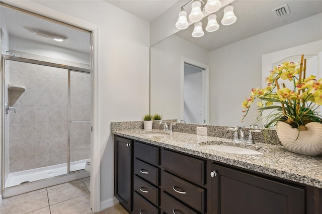 bathroom featuring tile patterned flooring, walk in shower, vanity, and toilet