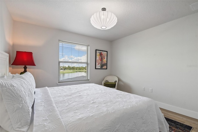 bedroom with hardwood / wood-style floors