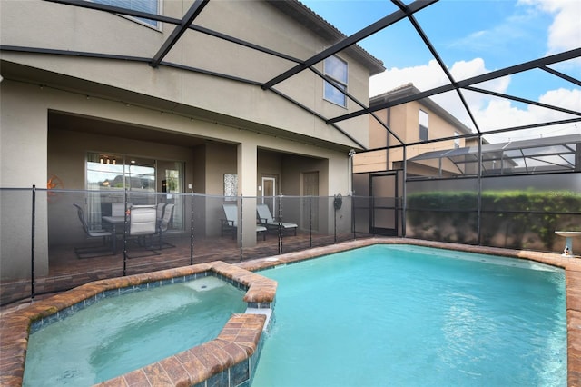 view of pool with an in ground hot tub, a patio area, and a lanai