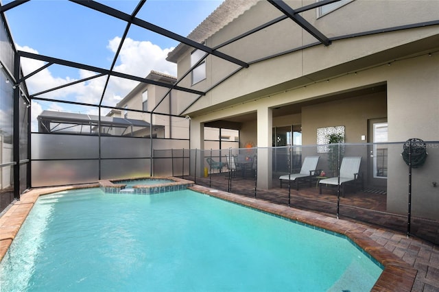 view of swimming pool featuring an in ground hot tub, glass enclosure, and a patio