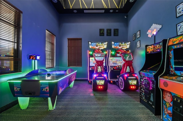 game room featuring carpet floors and a towering ceiling