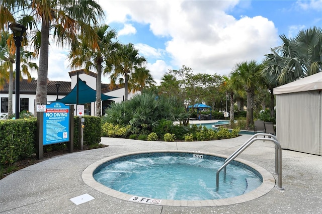 view of swimming pool featuring a community hot tub