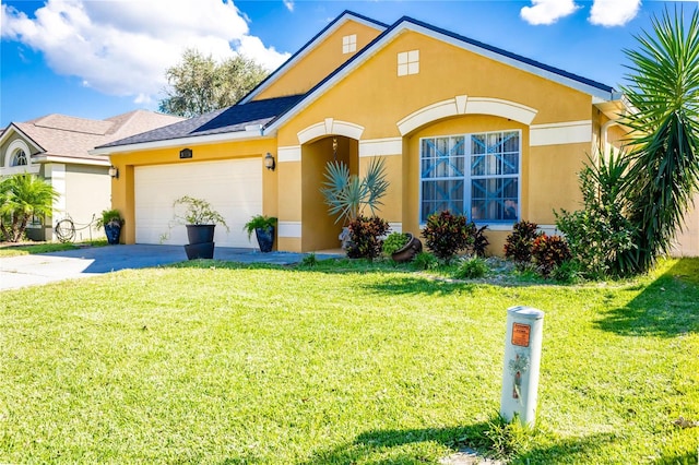 view of front of home with a garage and a front yard