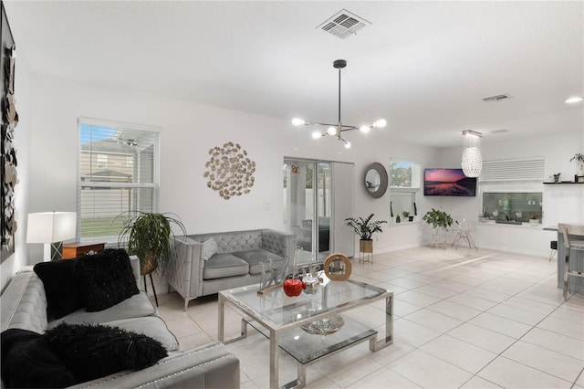 tiled living room featuring a wealth of natural light and a notable chandelier