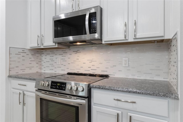 kitchen with backsplash, appliances with stainless steel finishes, stone countertops, and white cabinets