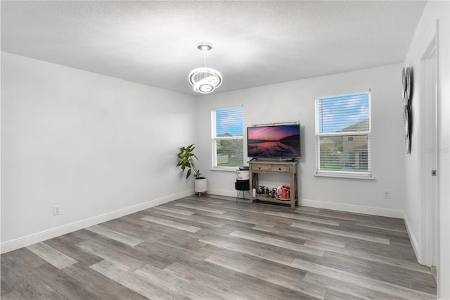 living room featuring light wood-type flooring and a textured ceiling