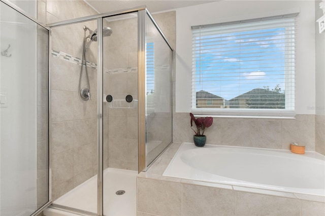 bathroom with shower with separate bathtub