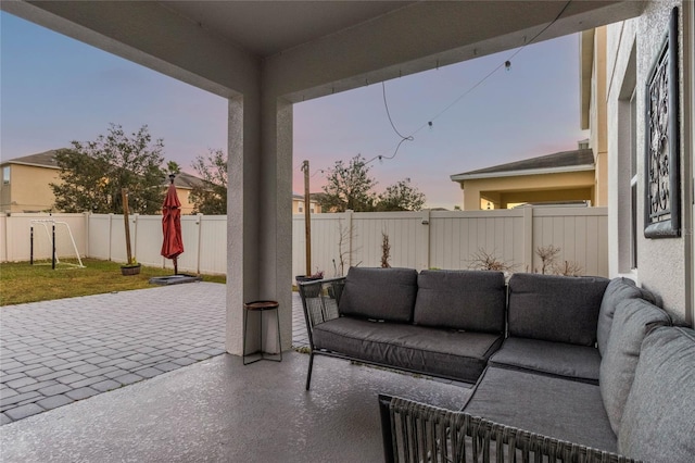 patio terrace at dusk featuring an outdoor living space