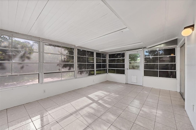 unfurnished sunroom with lofted ceiling and plenty of natural light