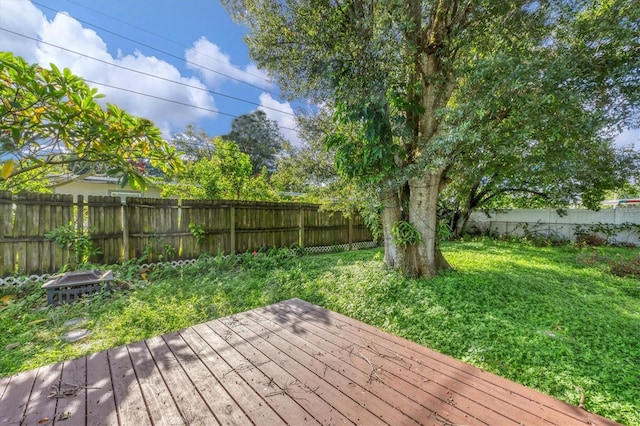 wooden terrace with a lawn