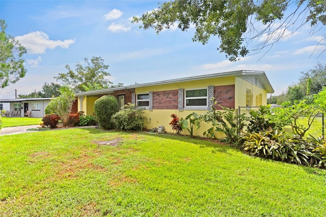 ranch-style home with a front lawn