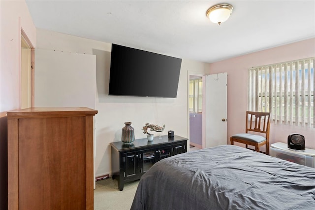 bedroom featuring light carpet