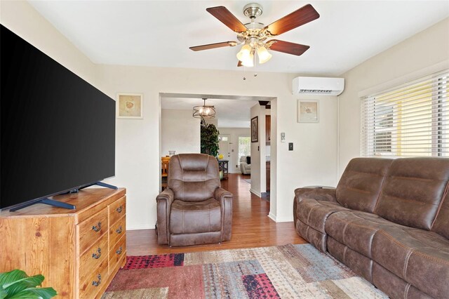 living room featuring ceiling fan, dark wood-type flooring, and an AC wall unit