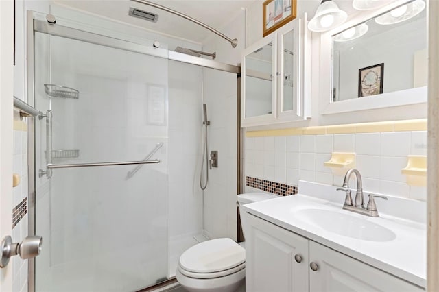 bathroom featuring decorative backsplash, walk in shower, vanity, and toilet