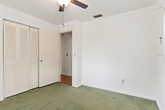 unfurnished bedroom featuring a closet, carpet, and ceiling fan