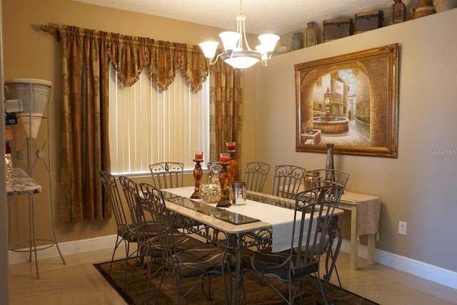 dining space featuring a chandelier and a textured ceiling