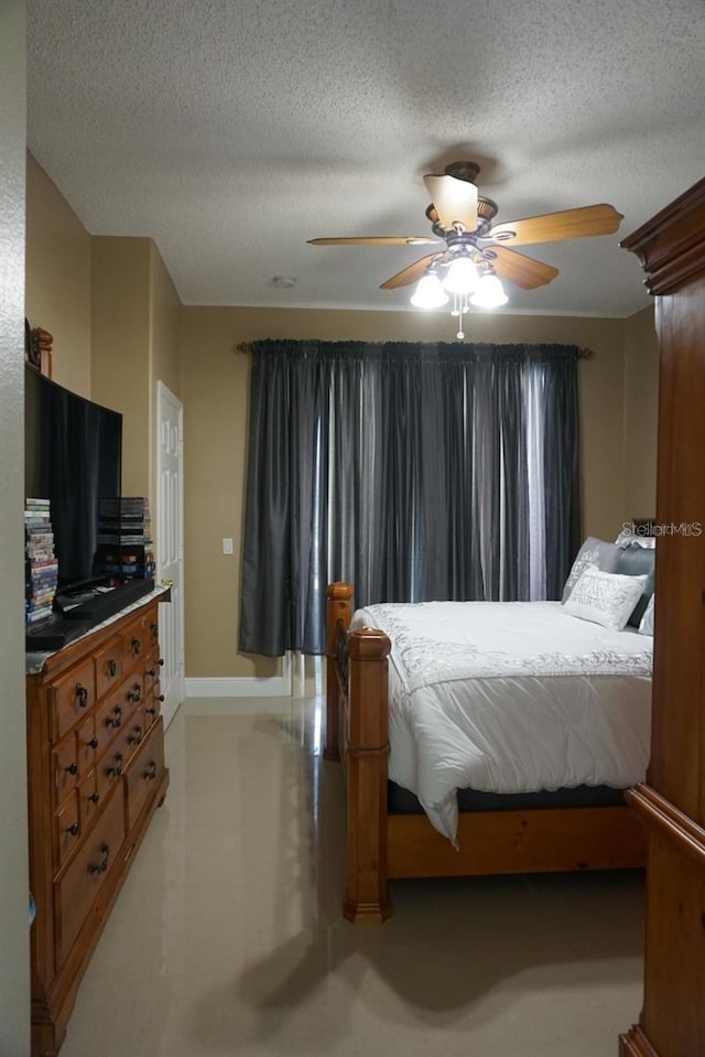 bedroom featuring a textured ceiling and ceiling fan