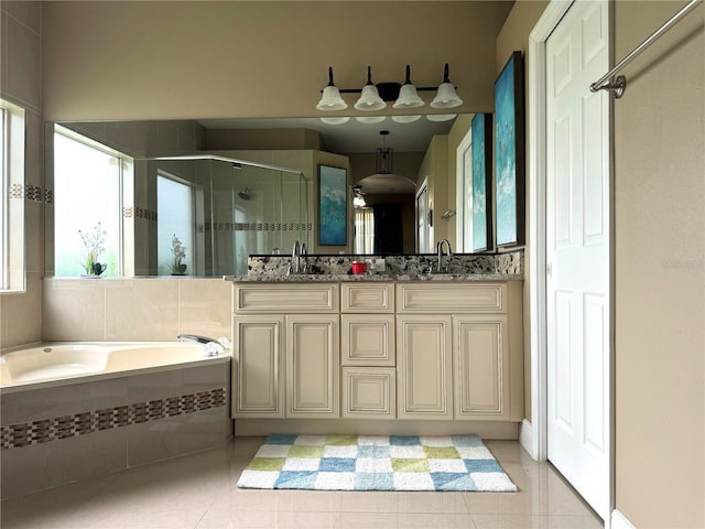 bathroom with tile patterned floors, vanity, and separate shower and tub