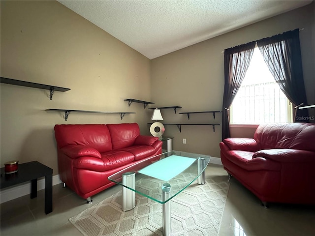 living room featuring lofted ceiling, a textured ceiling, and light tile patterned floors