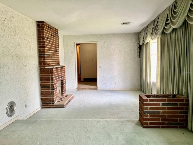 unfurnished living room featuring light carpet