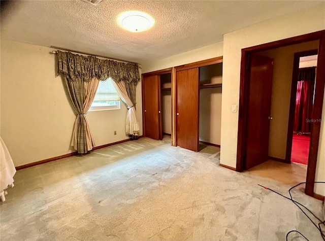 unfurnished bedroom featuring carpet floors and a textured ceiling