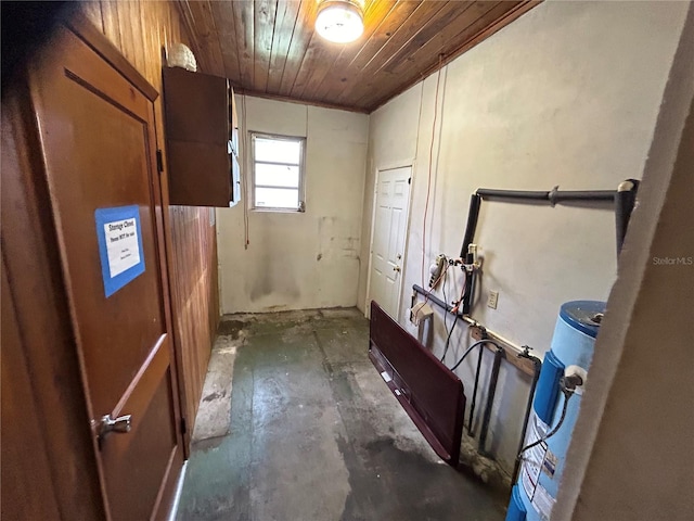 interior space with water heater and wooden ceiling